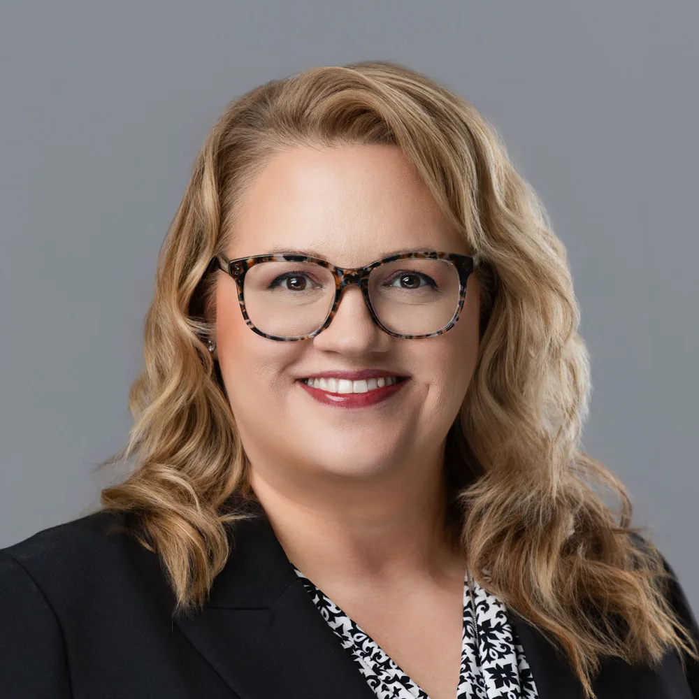 Corporate headshot on a gray backdrop