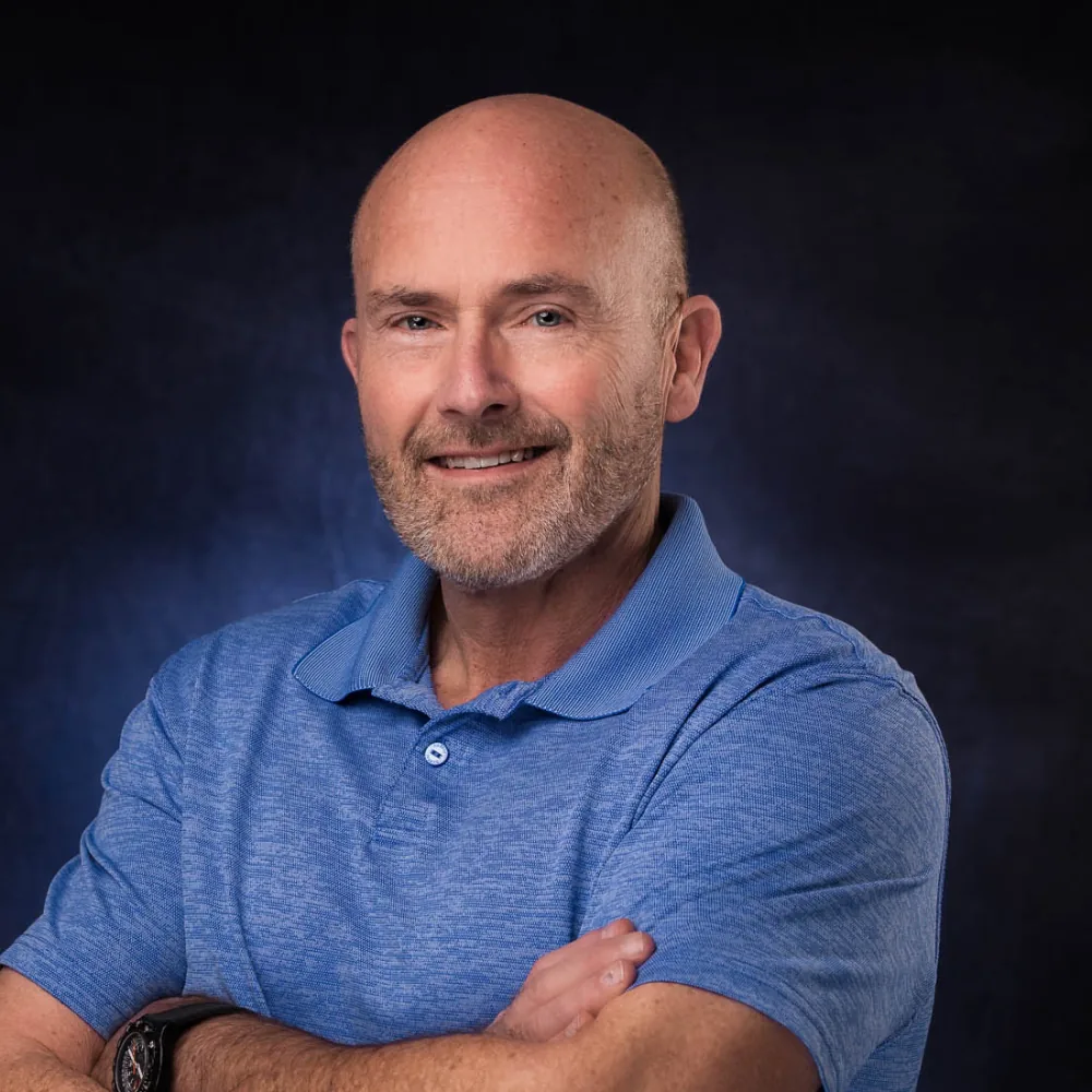 Corporate headshot on a gray backdrop